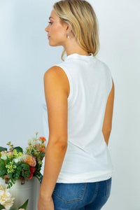 A sleeveless solid Ivory knit top